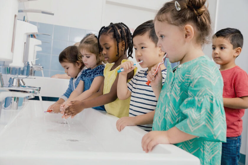 Children brushing their teeth in bathroom